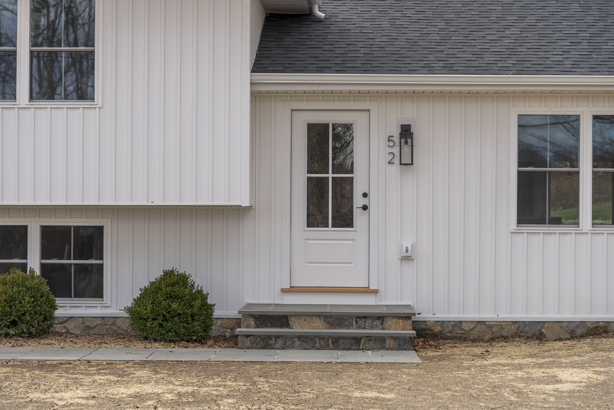 52 Curtis Road Bridgewater, CT 06752 - Photo 26 of 27 Inviting entry featuring a new walkway, boxwood plantings and outdoor lighting, seamlessly leading into the open-concept main level.