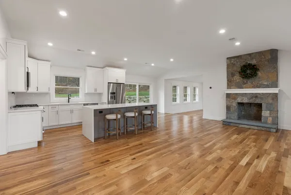 a living room with stainless steel appliances furniture or kitchen view and a living room view