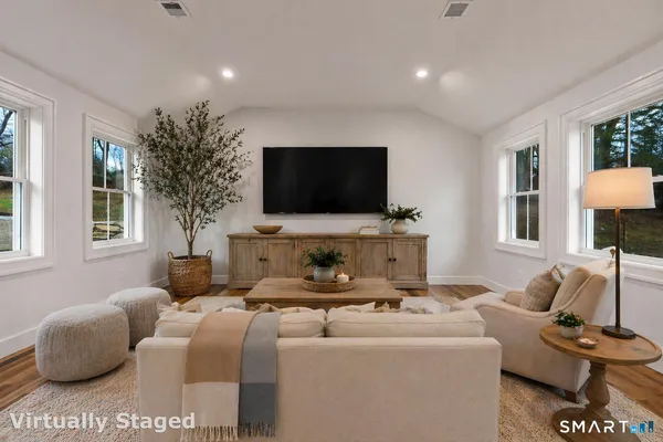 a living room with furniture and a flat screen tv