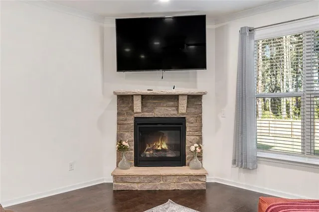 a living room with a fireplace and a flat screen tv