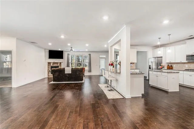a living room with furniture wooden floor and flat screen tv