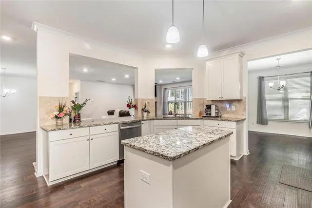 a kitchen with sink stove and cabinets