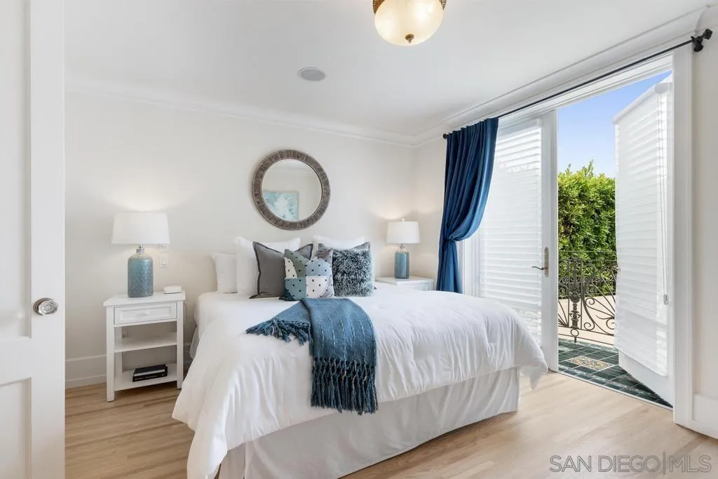 7971 Prospect Place La Jolla, CA 92037 - Photo 14 of 36 a bedroom with a bed mirror and a window