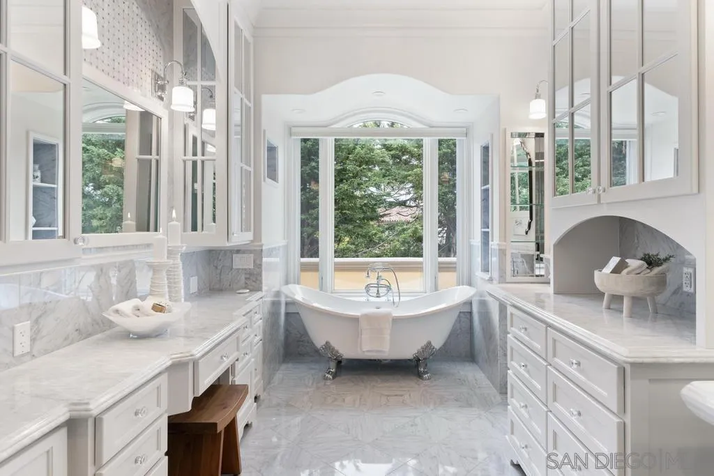 7971 Prospect Place La Jolla, CA 92037 - Photo 20 of 36 a bathroom with a tub sink and large window