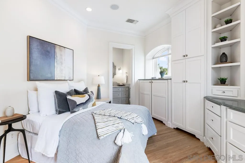 7971 Prospect Place La Jolla, CA 92037 - Photo 23 of 36 a bedroom with a bed and a cabinets