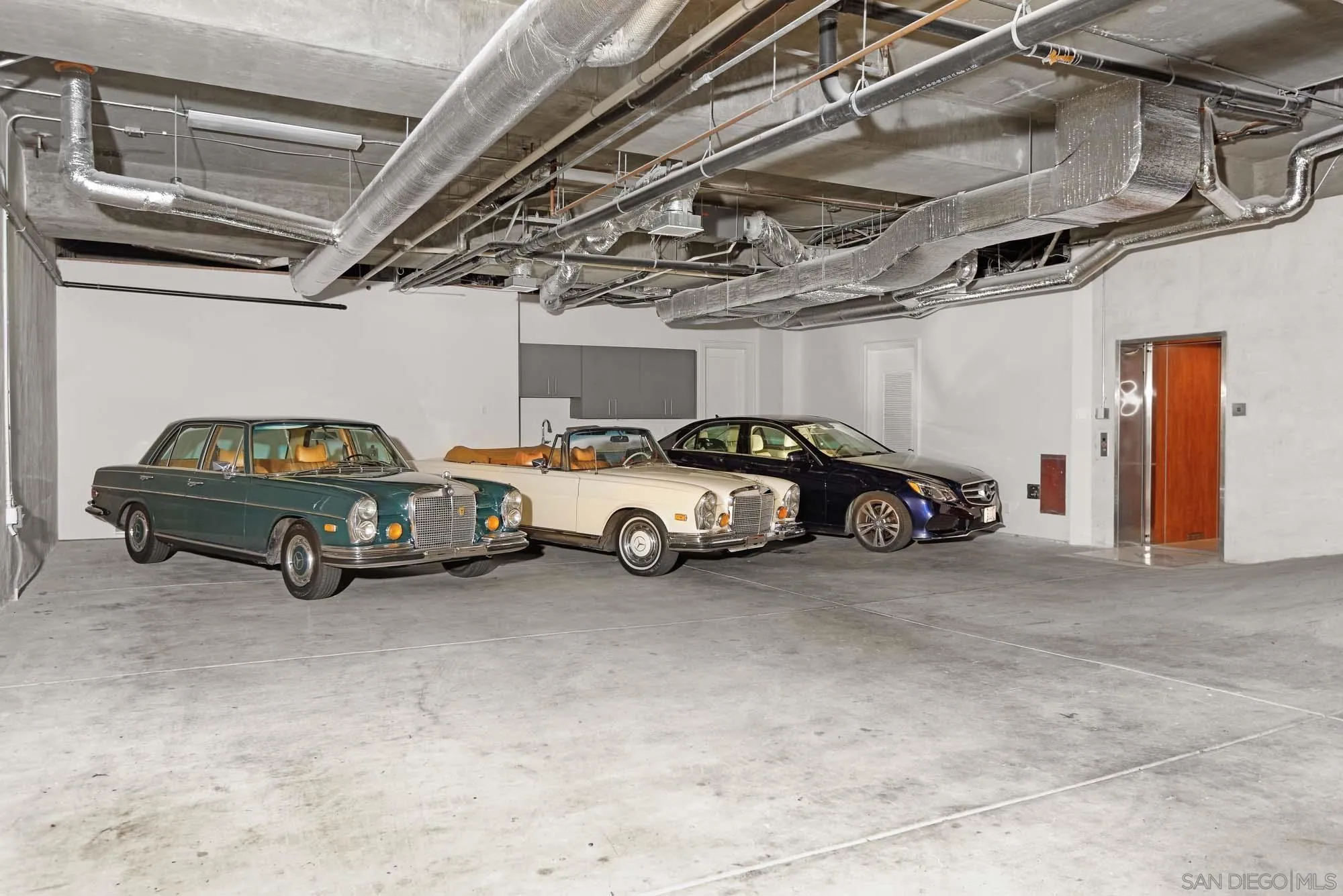7971 Prospect Place La Jolla, CA 92037 - Photo 27 of 36 a view of a garage with parked cars