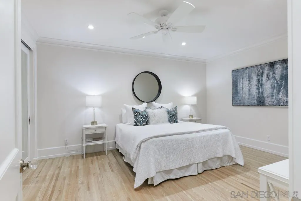 7971 Prospect Place La Jolla, CA 92037 - Photo 30 of 36 a bedroom with a bed and a chandelier