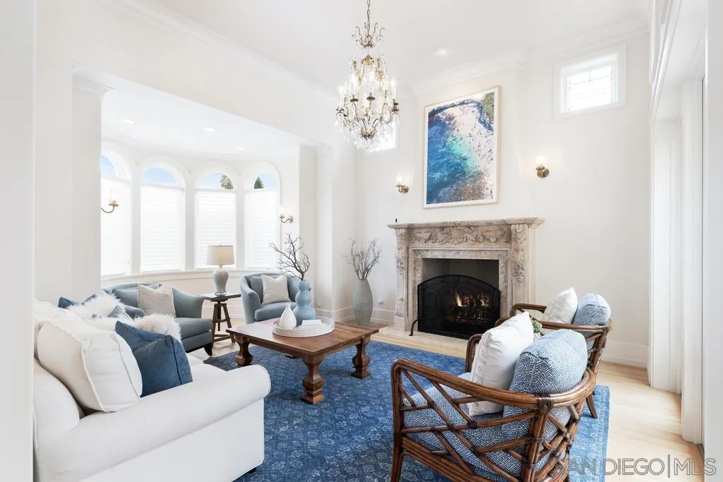 7971 Prospect Place La Jolla, CA 92037 - Photo 4 of 36 a living room with furniture potted plant and a fireplace