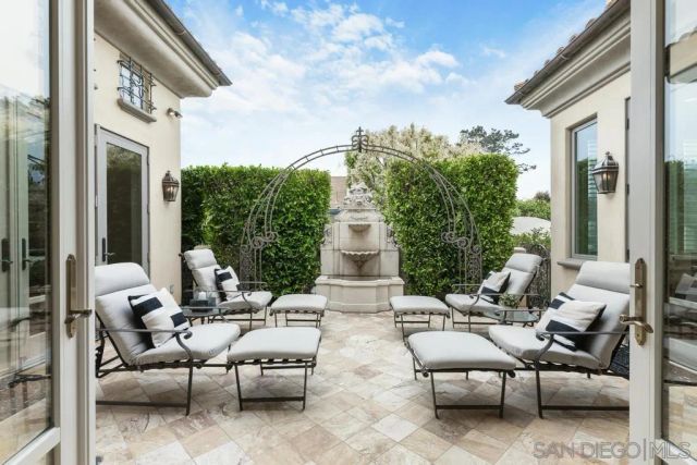 a view of a dining room with furniture a chandelier and wooden floor