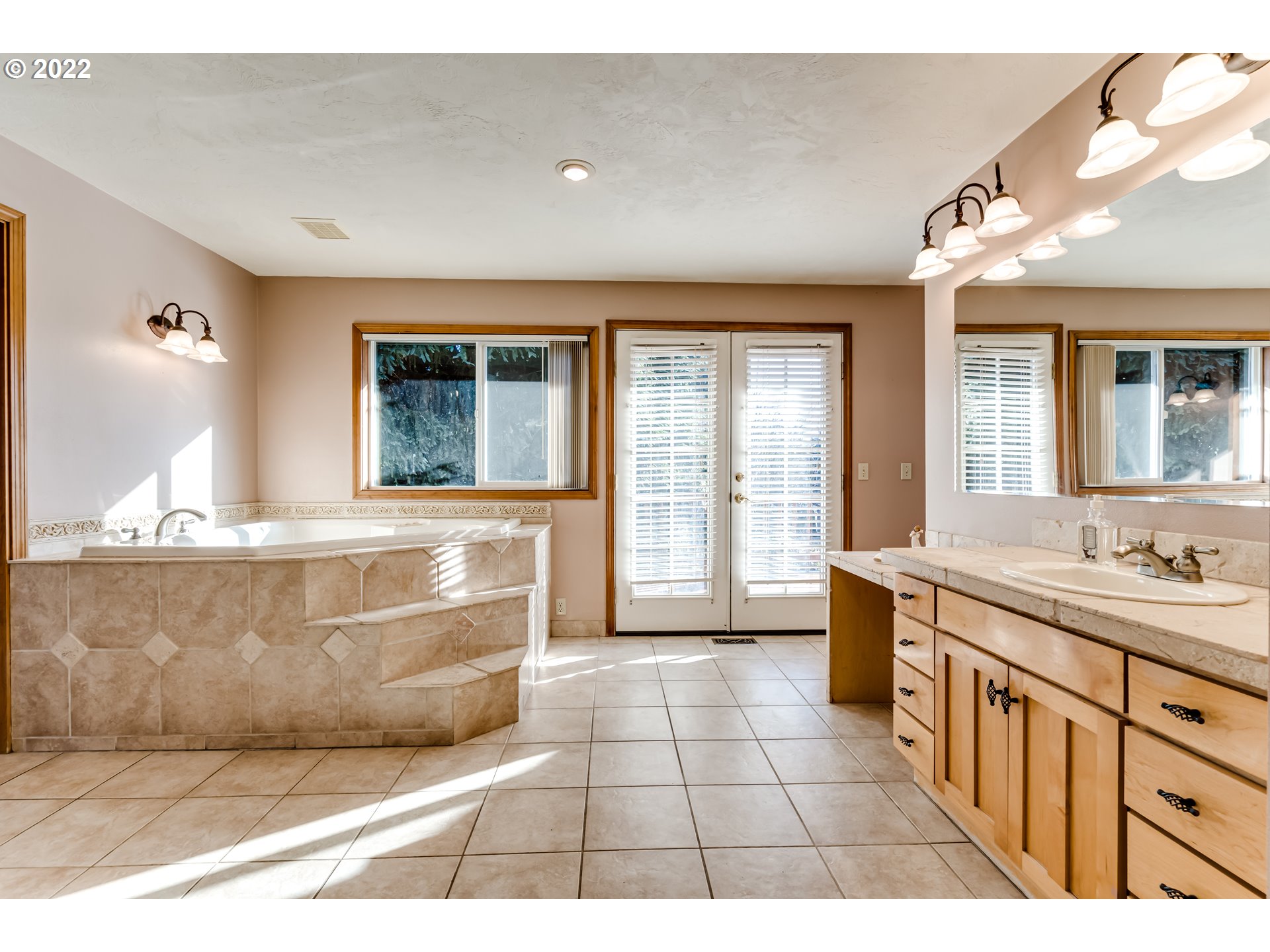 37577 Wheeler Road Dexter, OR 97431 - Photo 17 of 32 a bathroom with a tub a double vanity sink a mirror and a shower