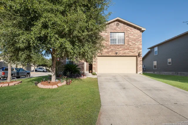 a front view of a house with a yard garage and fire pit