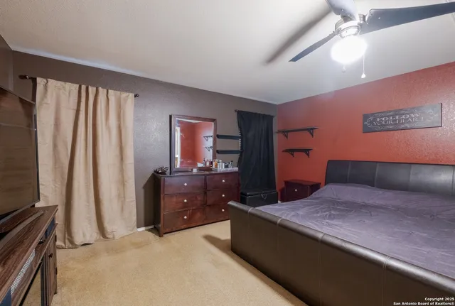 a bedroom with a large bed and a dresser