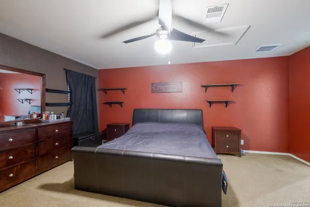 a bedroom with a bed and a dresser