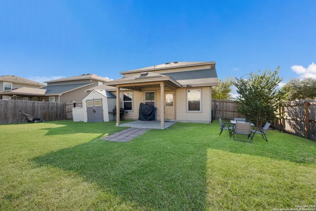 a view of a house with a backyard