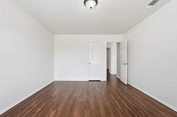 a view of a room with wooden floor