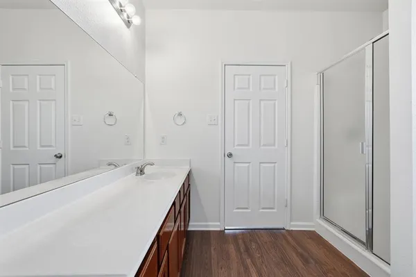 a spacious bathroom with a sink and a mirror