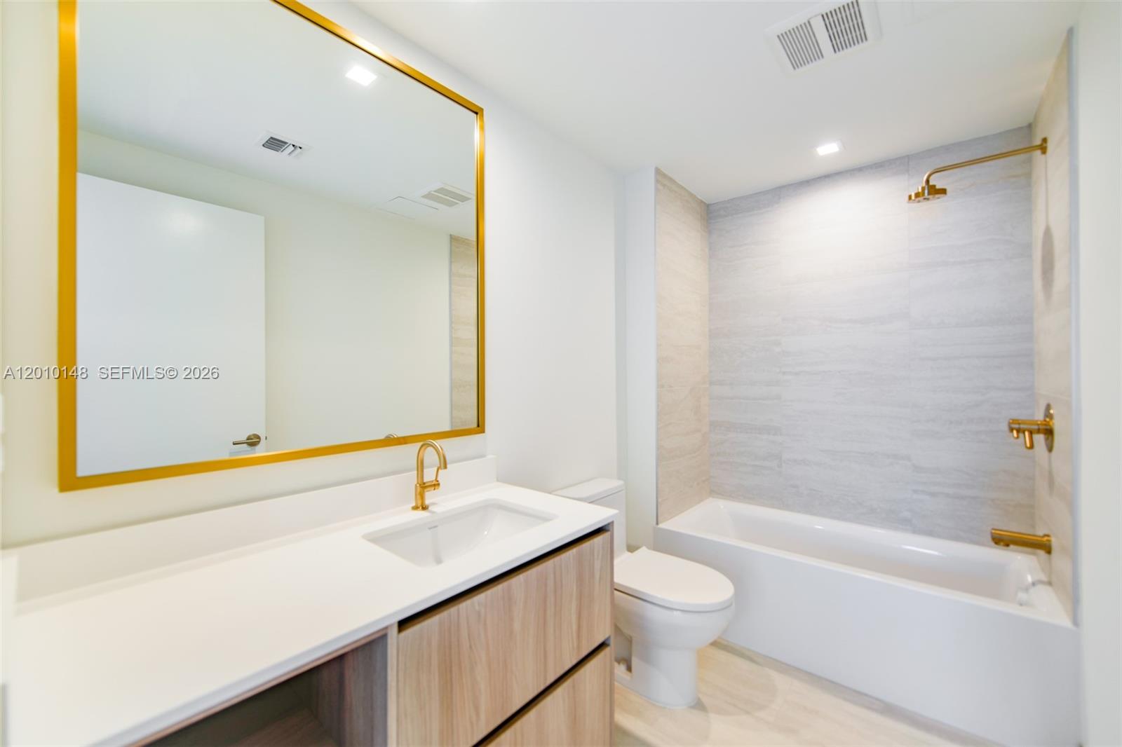 77 Southeast 5th Street, Unit 2604 Miami, FL 33131 - Photo 12 of 47 a bathroom with a sink a toilet and shower