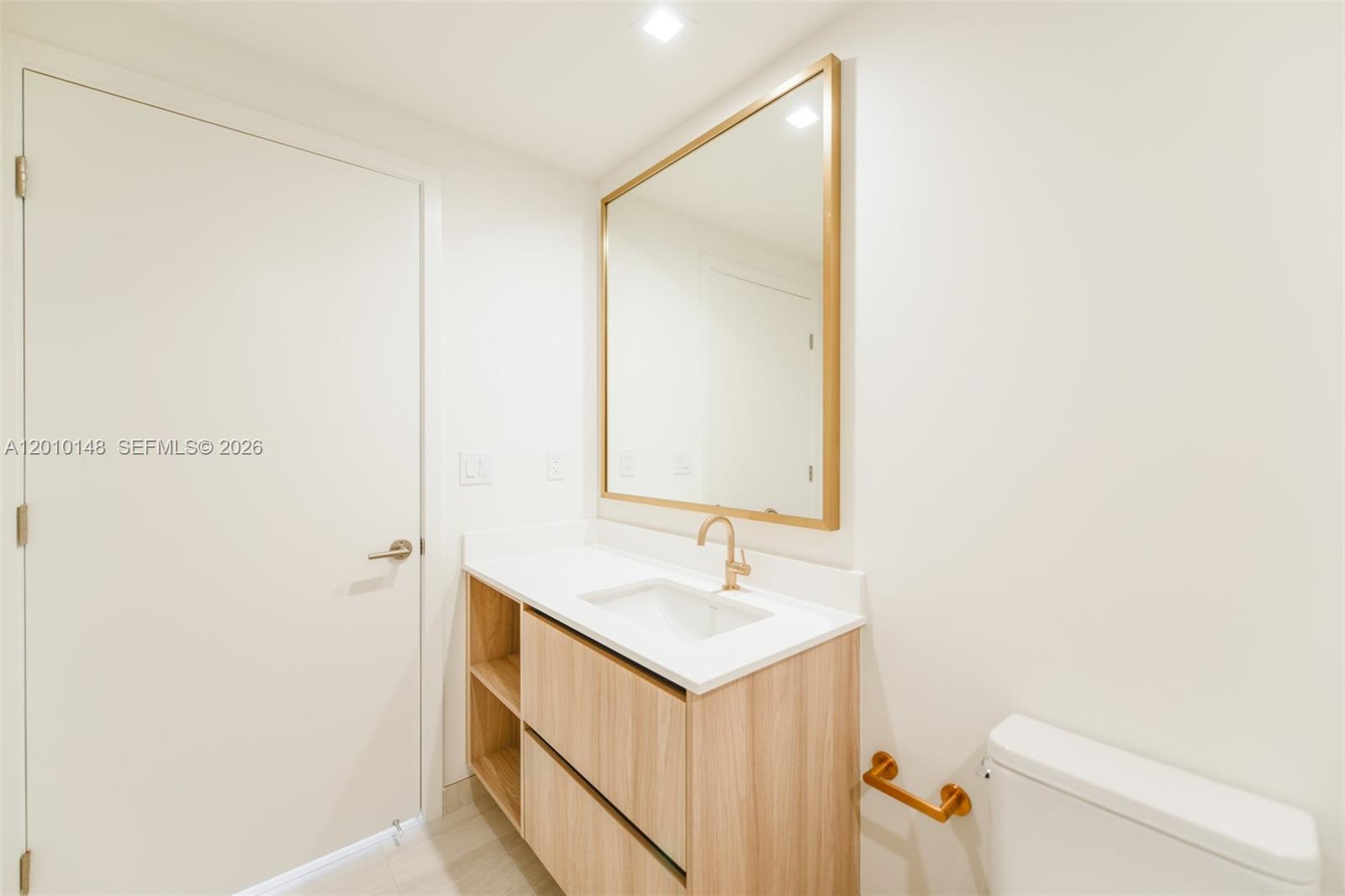 77 Southeast 5th Street, Unit 2604 Miami, FL 33131 - Photo 13 of 47 a bathroom with a sink and a mirror