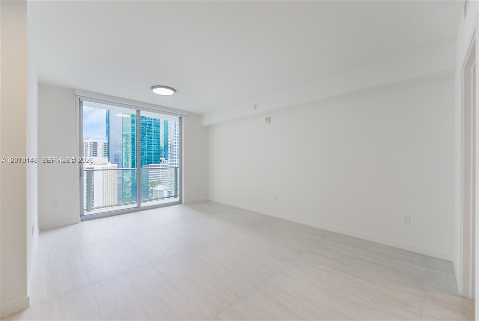 77 Southeast 5th Street, Unit 2604 Miami, FL 33131 - Photo 2 of 47 wooden floor in an empty room with a window