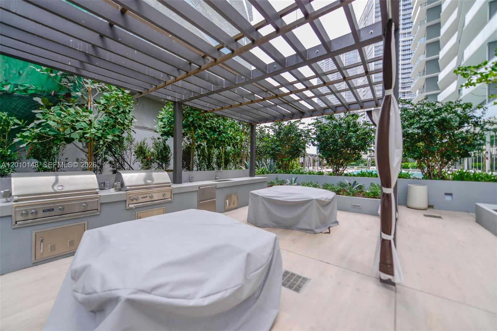 77 Southeast 5th Street, Unit 2604 Miami, FL 33131 - Photo 29 of 47 a swimming pool with outdoor seating and yard