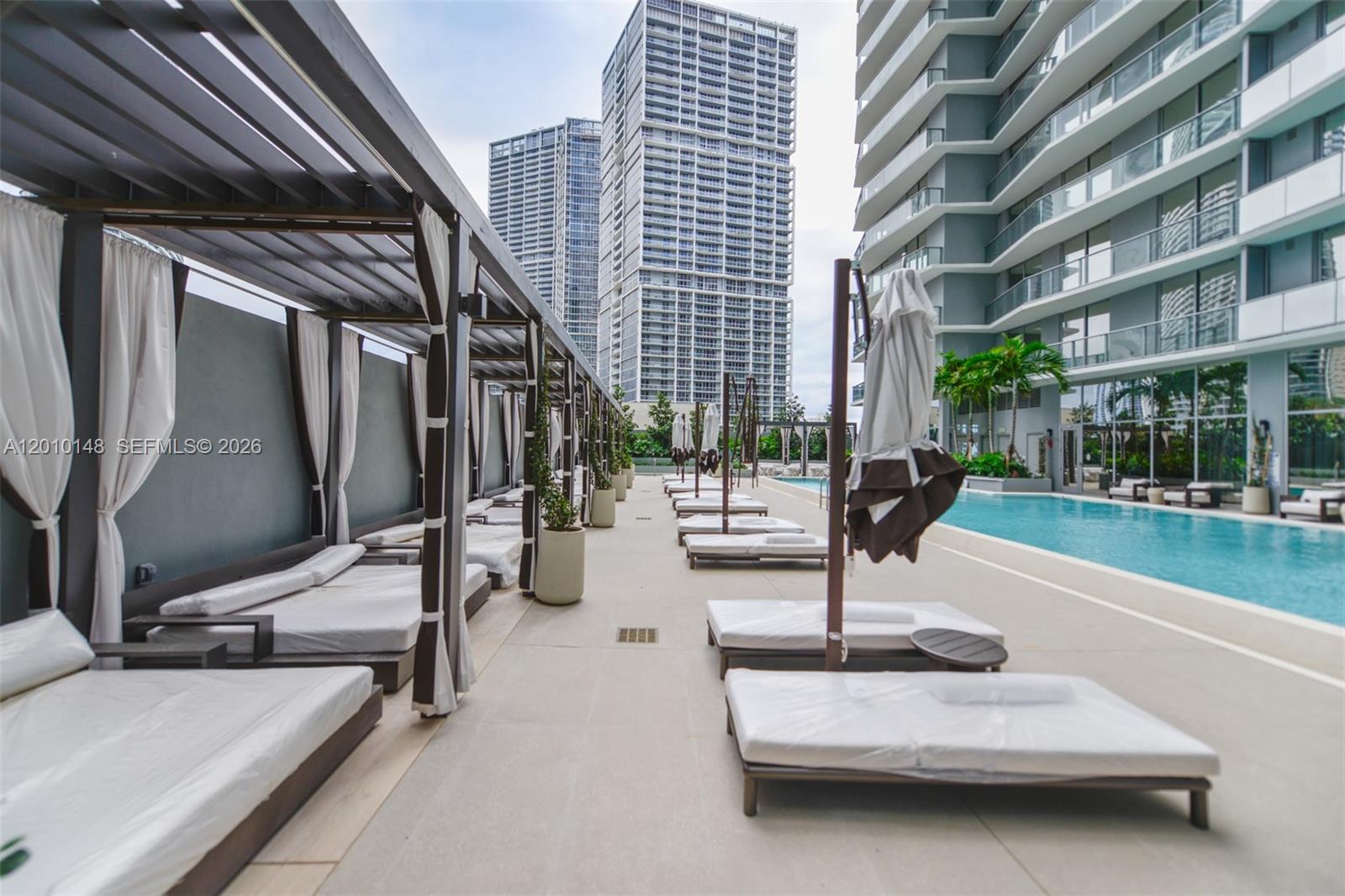 77 Southeast 5th Street, Unit 2604 Miami, FL 33131 - Photo 34 of 47 a view of a patio with a table and chairs
