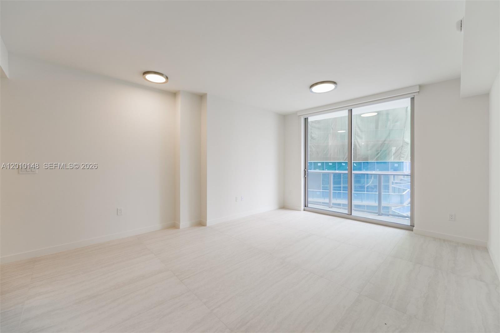 77 Southeast 5th Street, Unit 2604 Miami, FL 33131 - Photo 4 of 47 wooden floor and window in an empty room