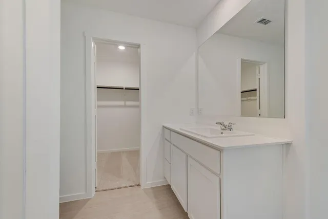 a bathroom with a sink a toilet and mirror