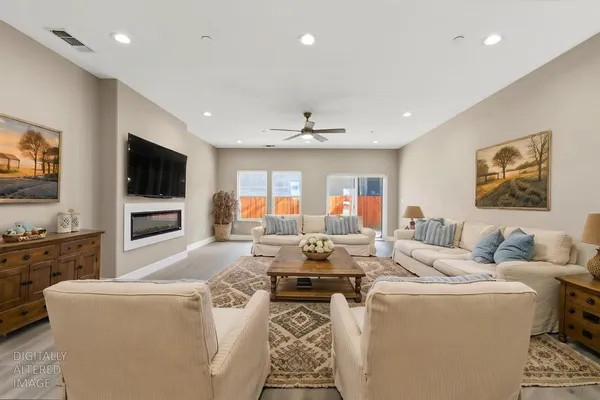 a living room with fireplace furniture and a flat screen tv
