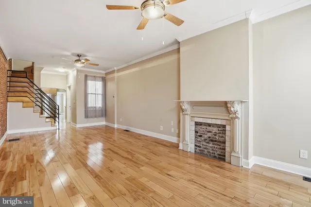 wooden floor in an empty room with a fireplace