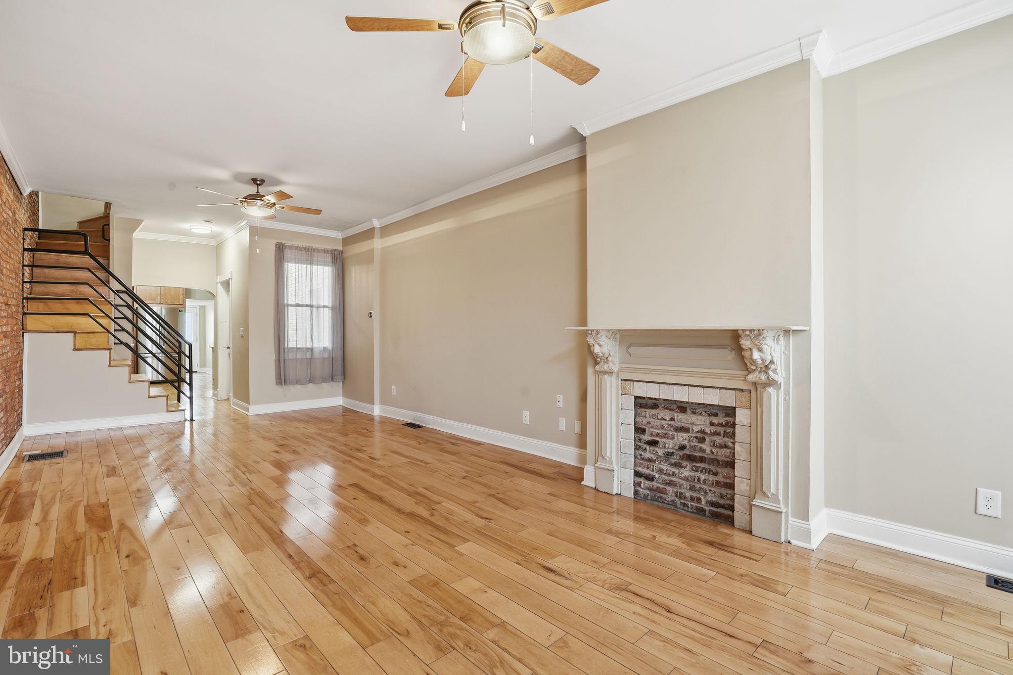 wooden floor in an empty room with a fireplace