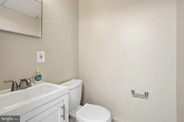 a bathroom with a sink a toilet and mirror