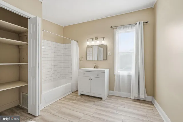 a bathroom with a sink a mirror and a shower