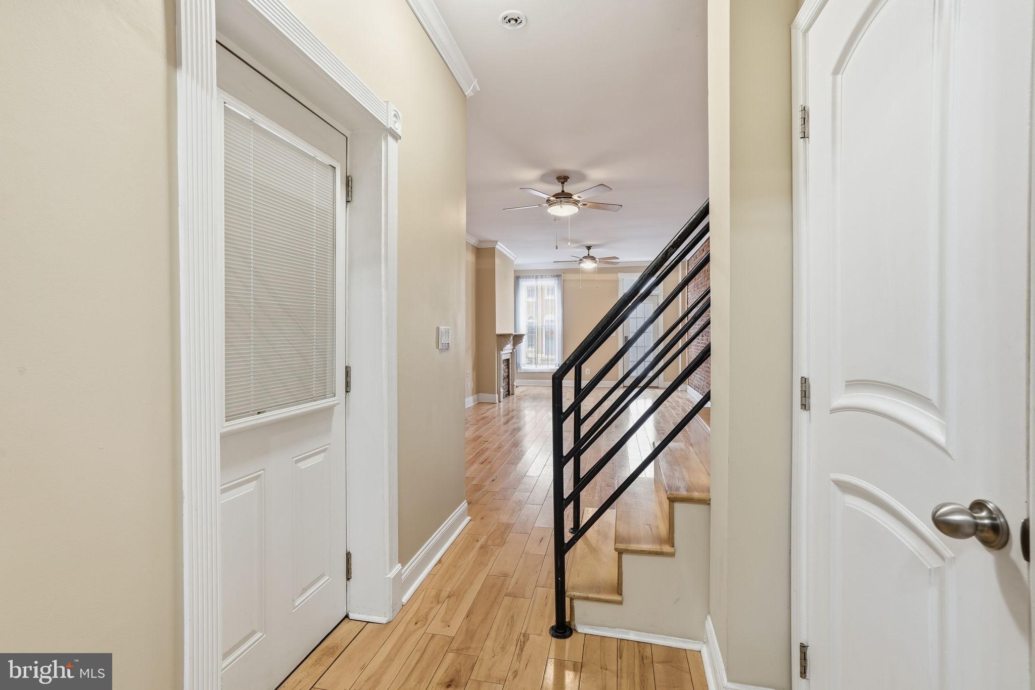 107 West Fort Avenue Baltimore, MD 21230 - Photo 8 of 34 a view of a hallway with wooden floor and staircase