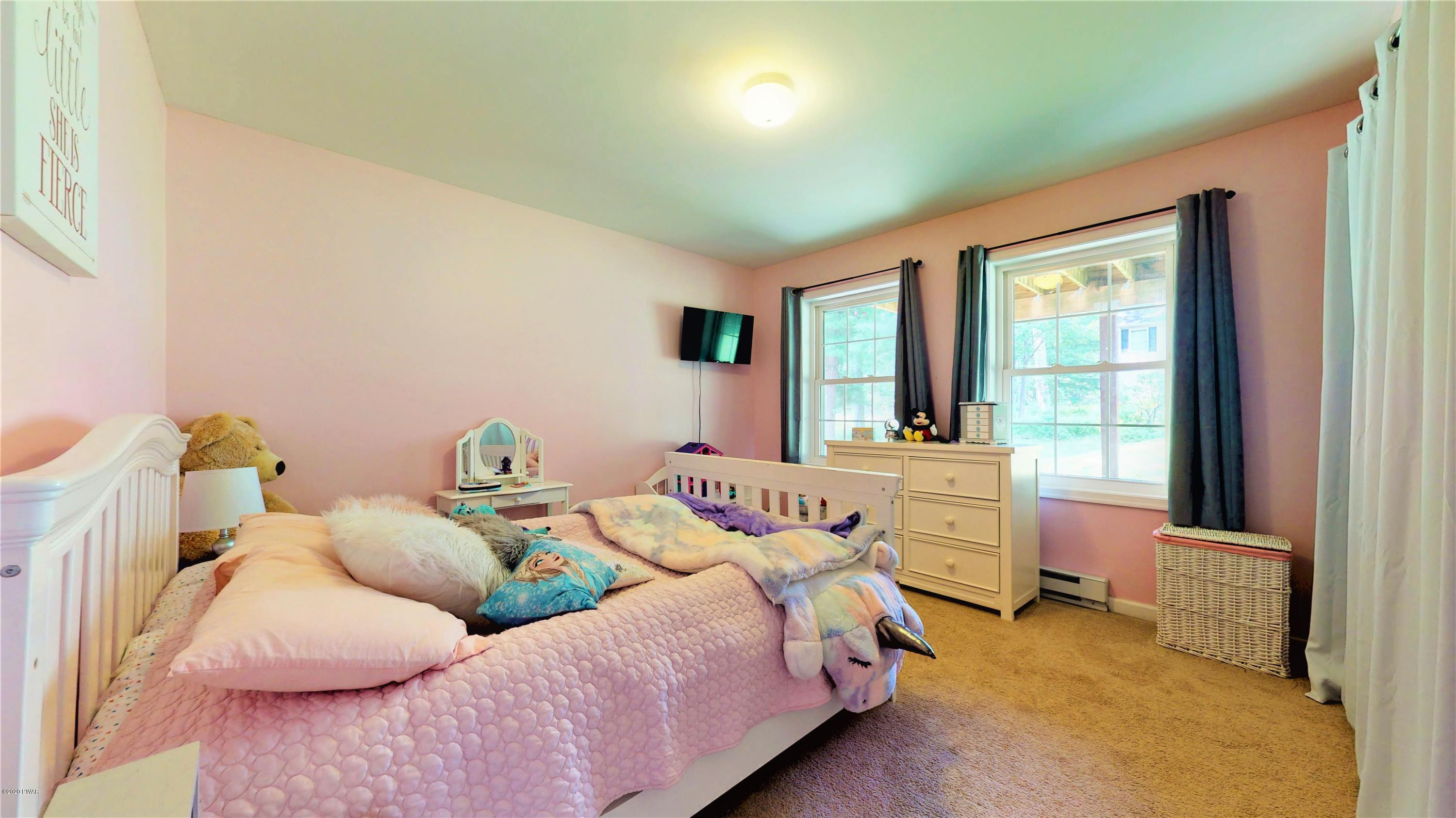 143 Raccoon Road Dingmans Ferry, PA 18328 - Photo 10 of 87 a bedroom with a bed and a large window
