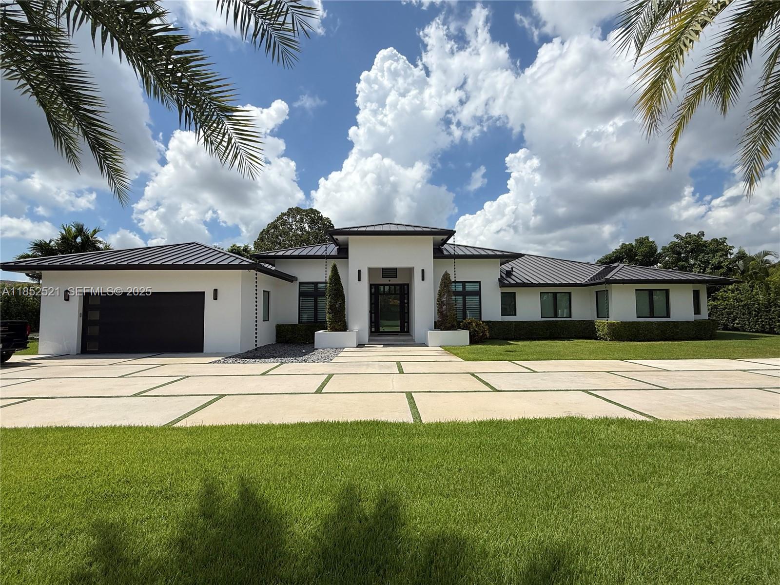 a view of a house with a swimming pool and a yard