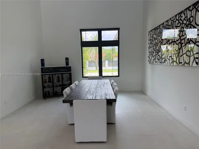 a bedroom with a bed chair and a large window