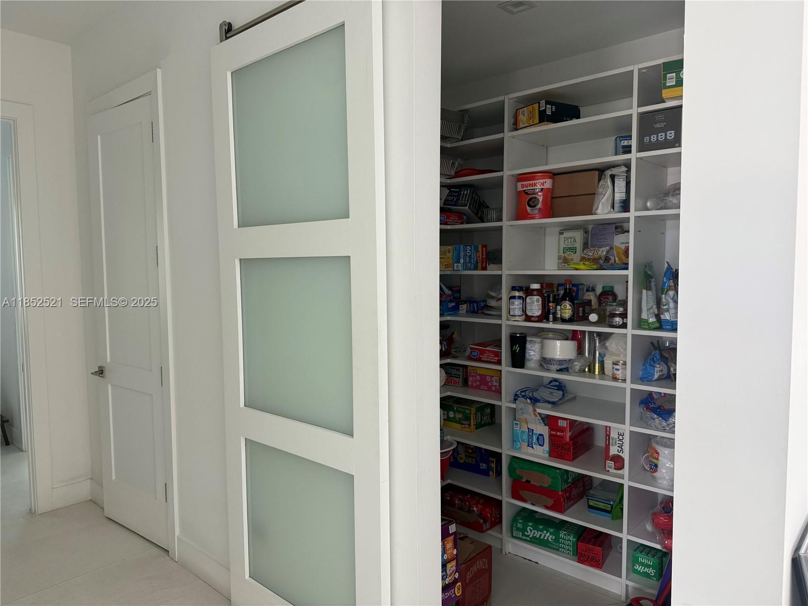 9600 Southwest 66th Street Miami, FL 33173 - Photo 16 of 56 a room with shelves on the wall