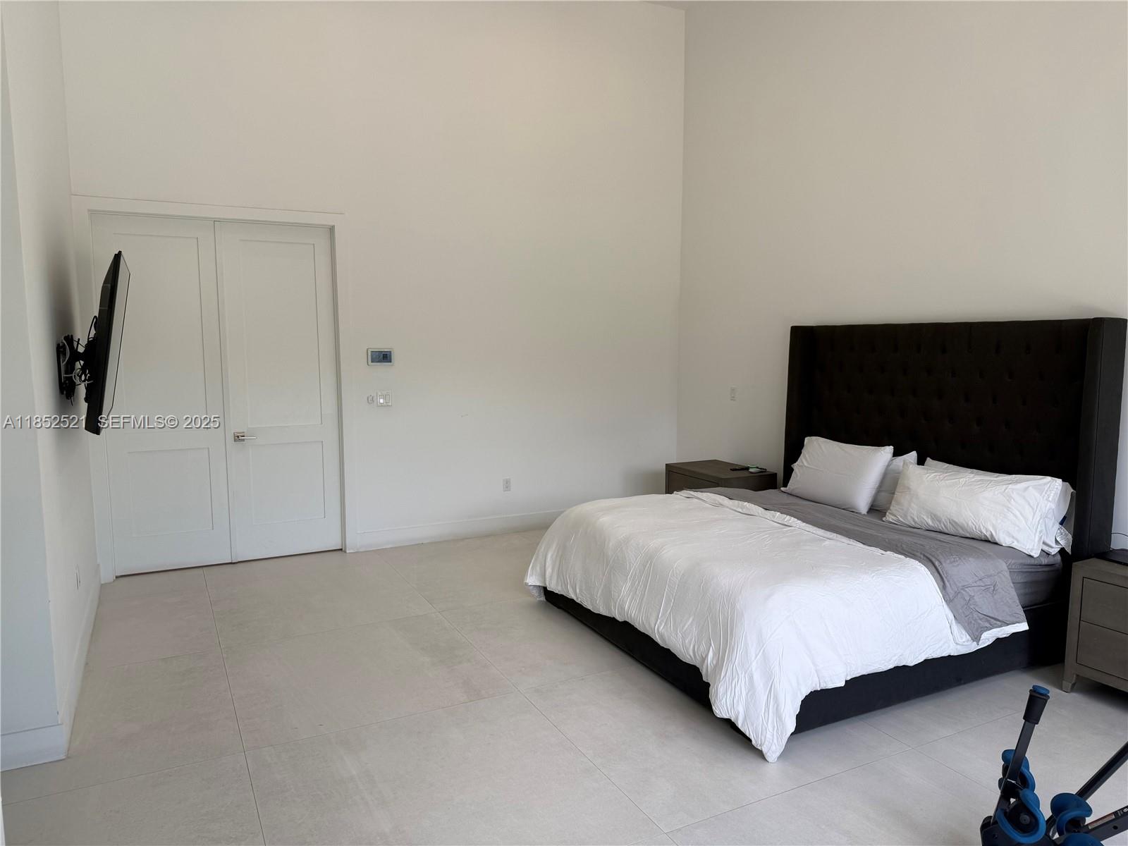 9600 Southwest 66th Street Miami, FL 33173 - Photo 20 of 56 a bedroom with a bed and a night stand