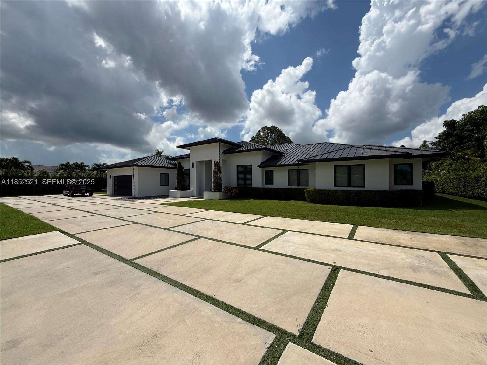 9600 Southwest 66th Street Miami, FL 33173 - Photo 2 of 56 a house with a large window and palm trees