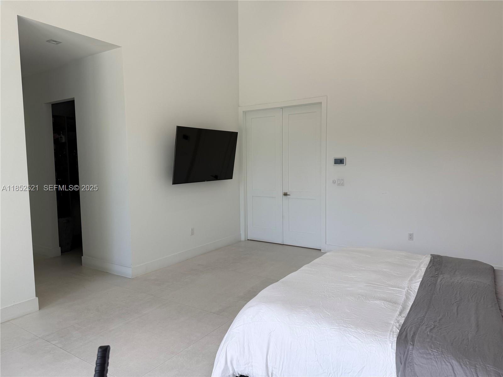 9600 Southwest 66th Street Miami, FL 33173 - Photo 21 of 56 a bedroom with a bed and a flat screen tv