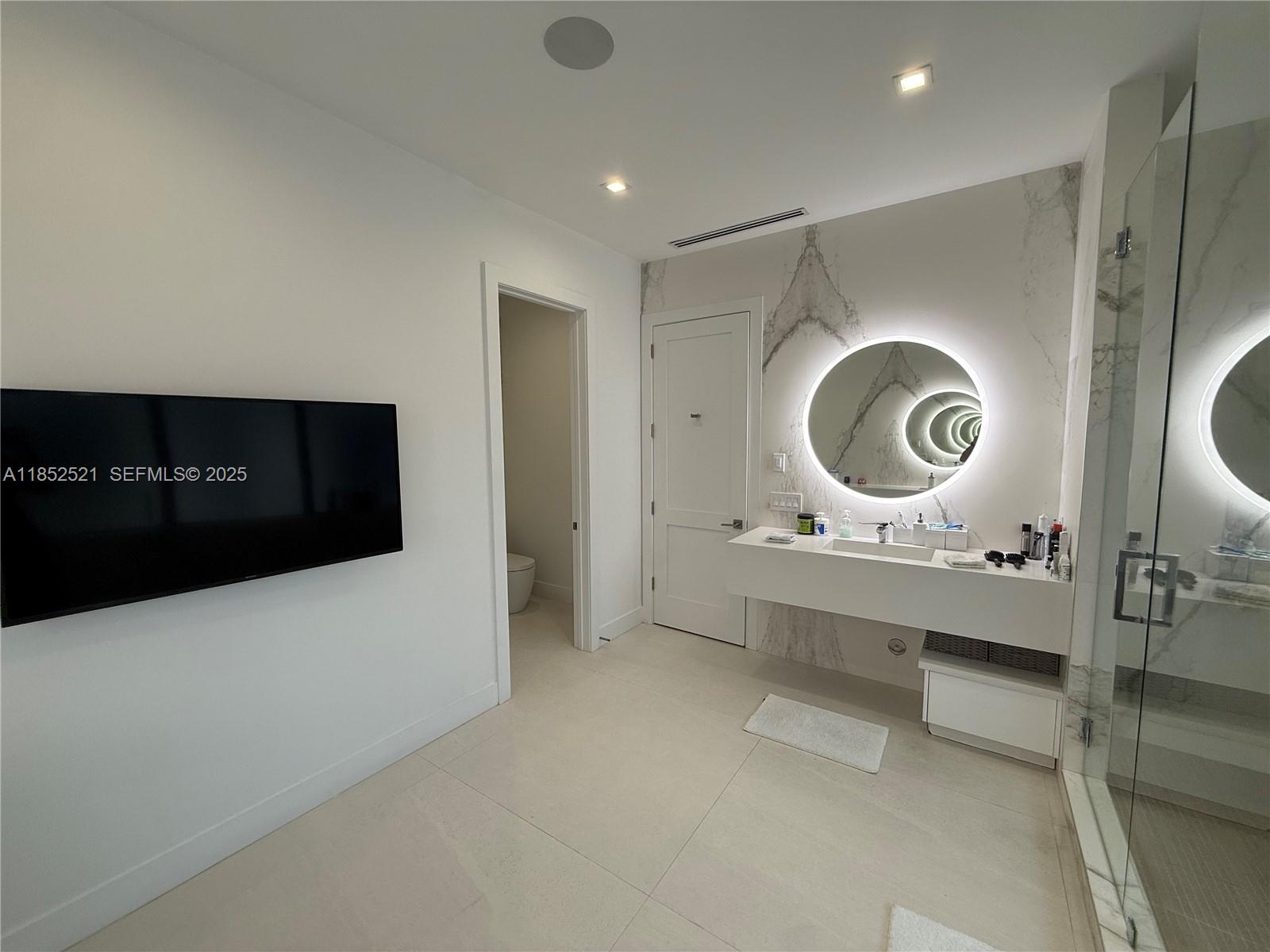 9600 Southwest 66th Street Miami, FL 33173 - Photo 27 of 56 a living room with a mirror and a wooden floor