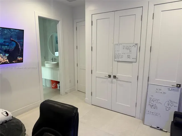 a spacious bedroom with a bed and a flat screen tv