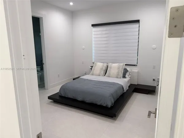 a bedroom with a bed and wall painting