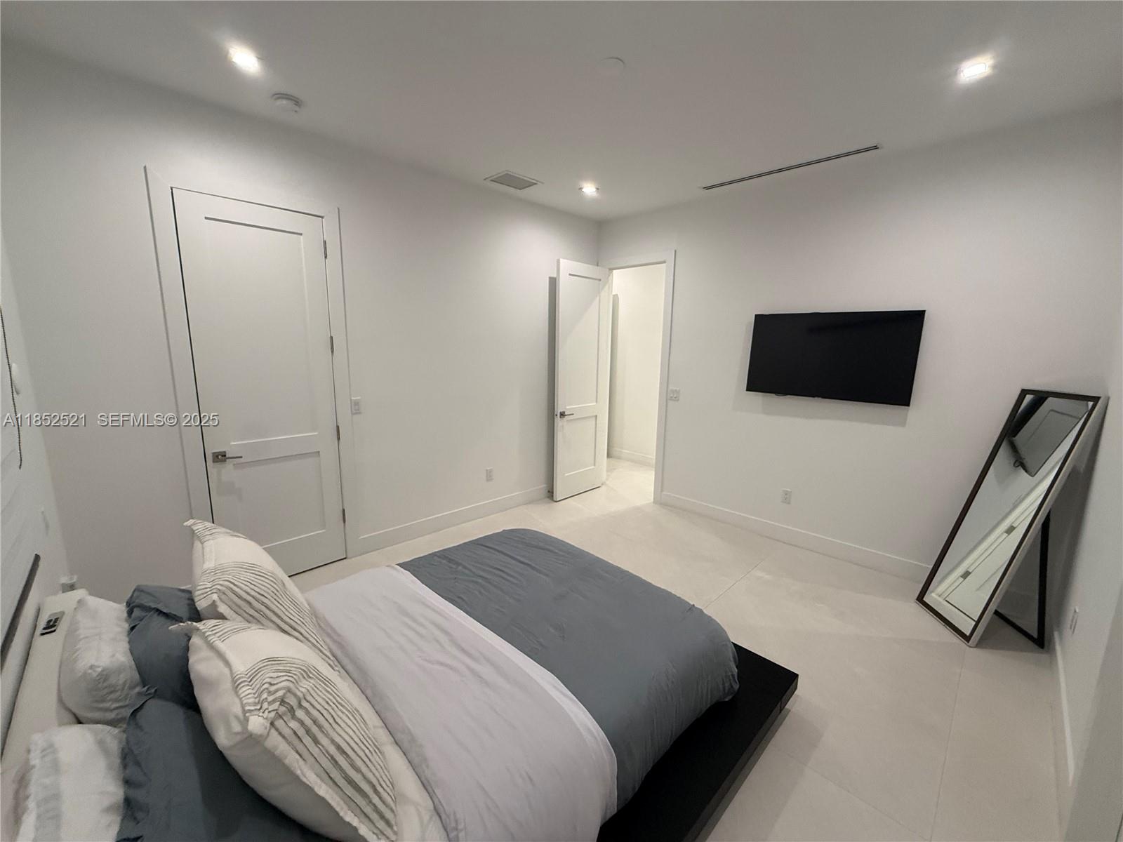 9600 Southwest 66th Street Miami, FL 33173 - Photo 35 of 56 a bedroom with a bed and a flat screen tv