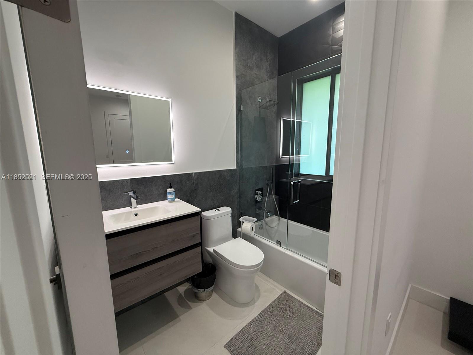 9600 Southwest 66th Street Miami, FL 33173 - Photo 36 of 56 a bathroom with a toilet sink and mirror