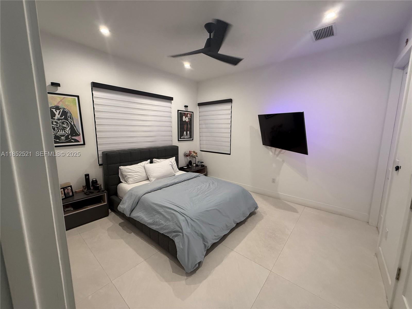 9600 Southwest 66th Street Miami, FL 33173 - Photo 37 of 56 a spacious bedroom with a bed and a flat screen tv