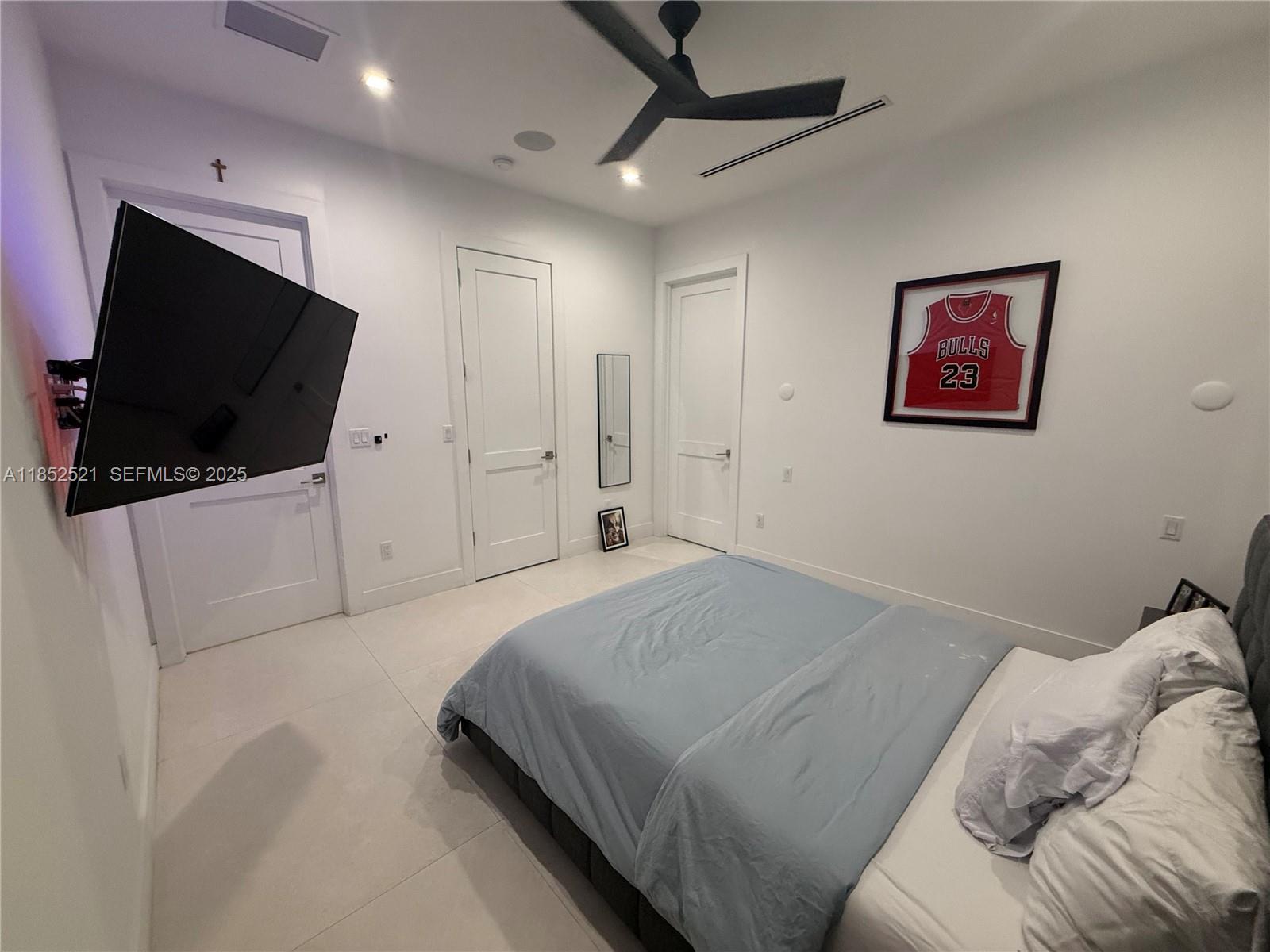 9600 Southwest 66th Street Miami, FL 33173 - Photo 39 of 56 a bedroom with a bed and a flat screen tv