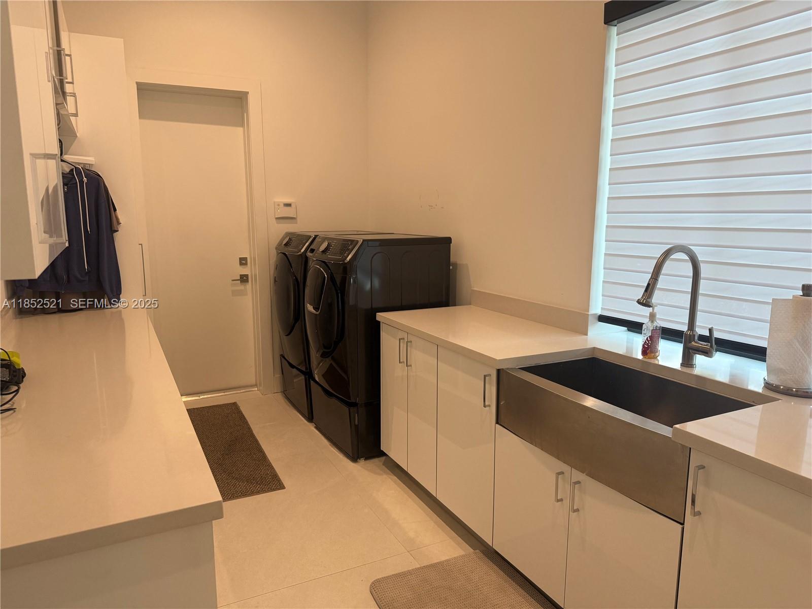 9600 Southwest 66th Street Miami, FL 33173 - Photo 40 of 56 a view of storage and utility room with washer and dryer