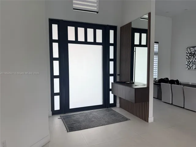 a living room with furniture and large windows