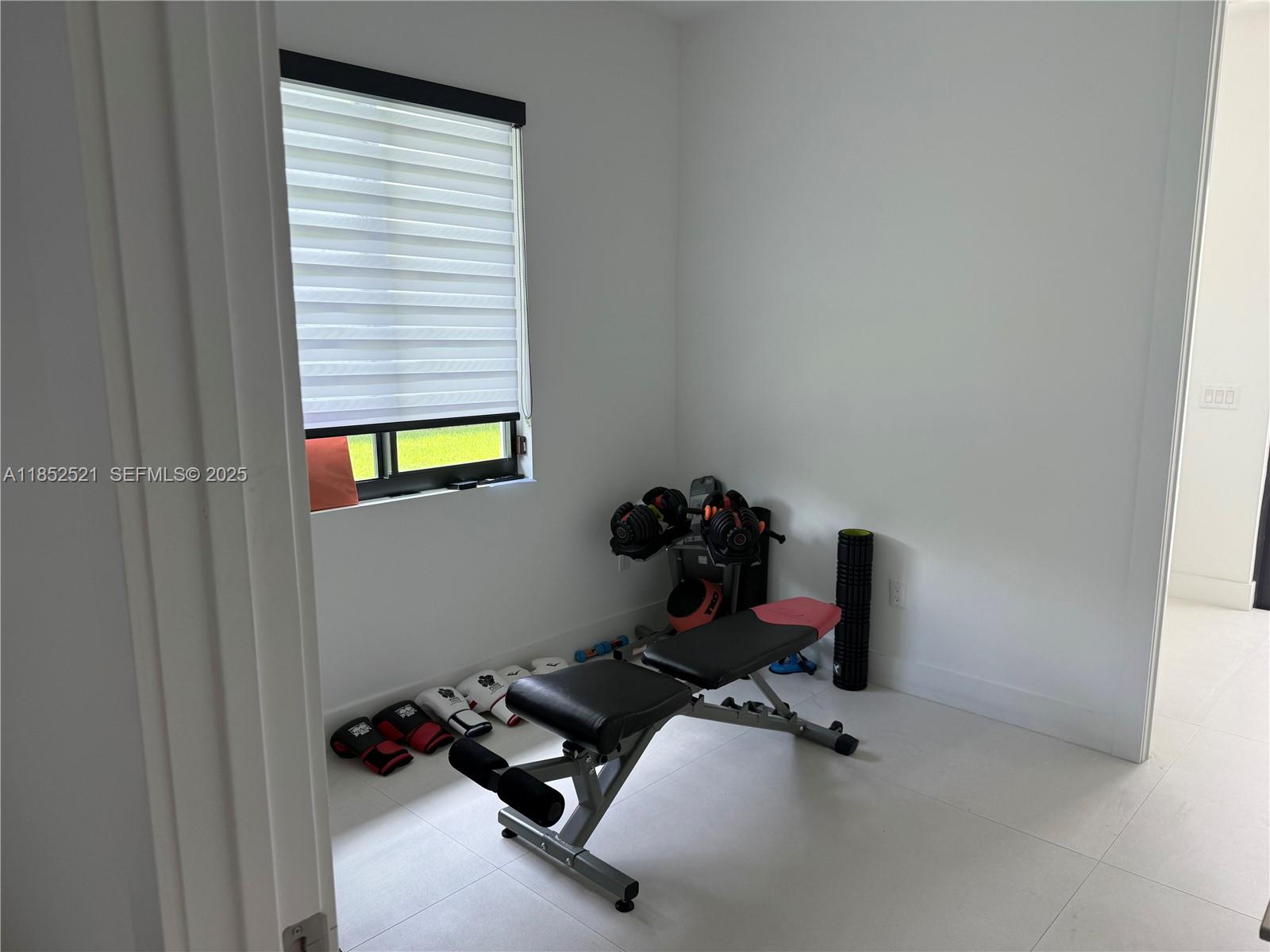 9600 Southwest 66th Street Miami, FL 33173 - Photo 41 of 56 a room with gym equipment and a window